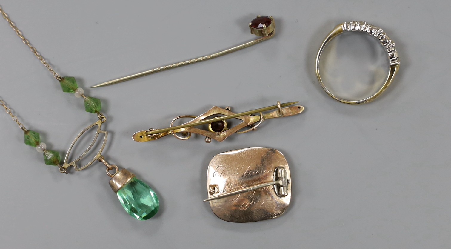 A George III yellow metal and plaited hair mourning brooch, initialled 'WA' and inscribed 'Eliz. Robinson obt. 5th July, 1815 at 12', 22mm, a 9ct and gem set bar brooch, a 9ct and green paste set necklace and two other i